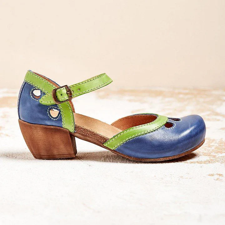 Blue and green leather Mary Jane shoe with wooden block heel, featuring cutout details and adjustable strap. Stylish women's footwear.