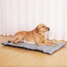 Foldable waterproof outdoor dog mat, gray, durable travel pet bed on wooden floor.