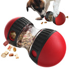 Red interactive dog treat dispenser toy with transparent center, filled with assorted pet snacks. Engaging puzzle feeder for pet enrichment.