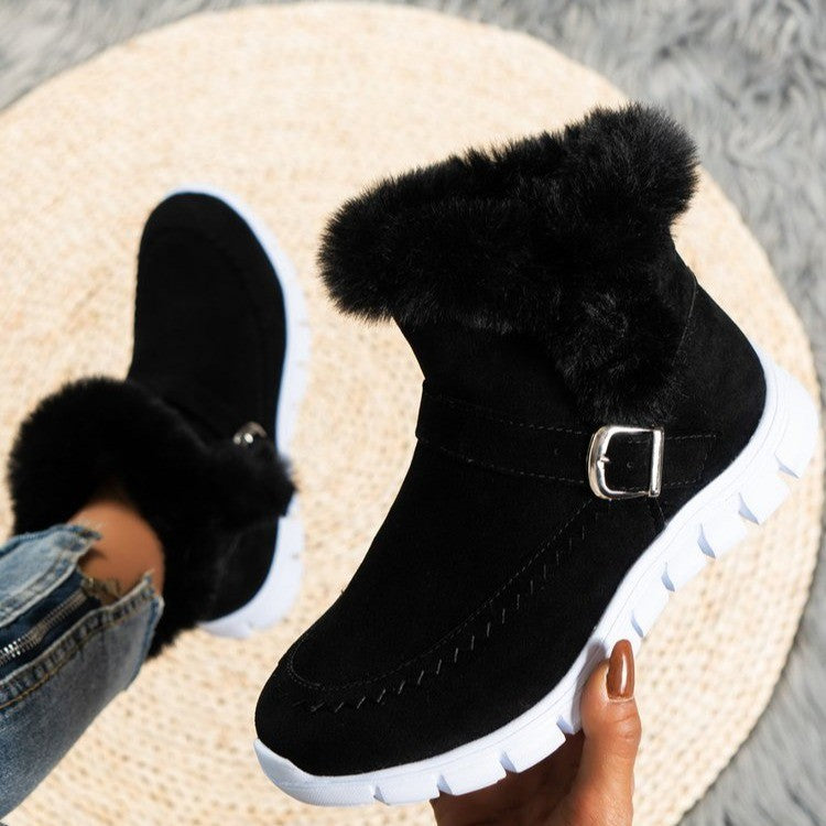 Black suede winter boots with faux fur lining and white rubber soles, featuring a side buckle. Perfect for cold weather fashion and comfort.