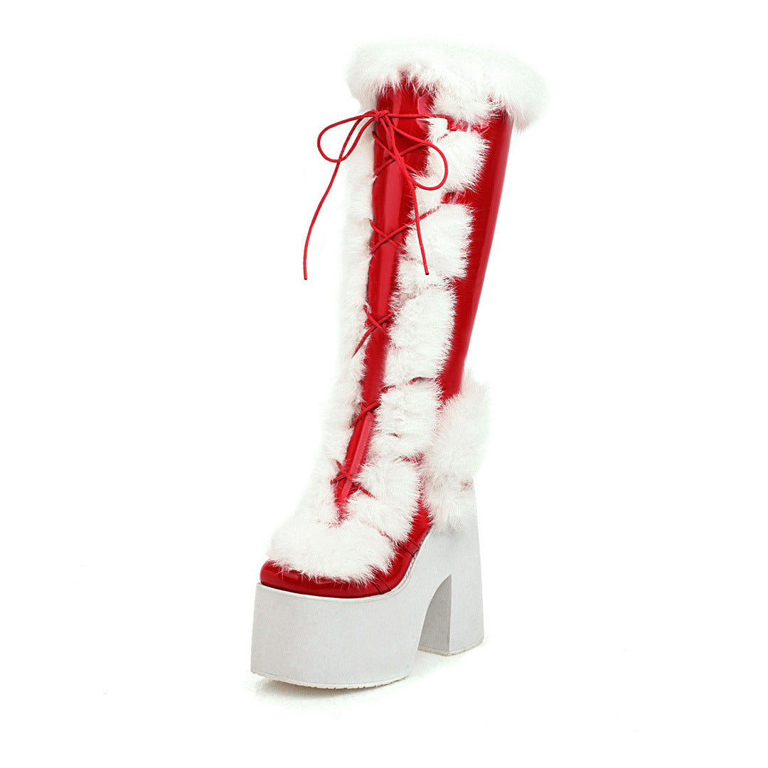 Red and white platform boot with faux fur trim and lace-up design, featuring a high chunky heel. Perfect for cosplay or festive fashion.