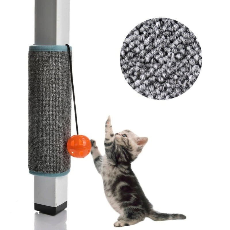 Kitten playing with orange ball on a scratching post attached to a table leg, featuring durable gray carpet texture. Perfect cat furniture accessory.