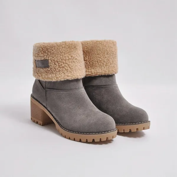 Gray suede ankle boots with faux fur cuff, block heel, and lug sole. Stylish winter footwear for women. Perfect for cold weather fashion.