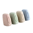 Set of four pastel-colored, speckled soap dispensers in pink, green, beige, and blue. Modern bathroom accessories, stylish home decor.