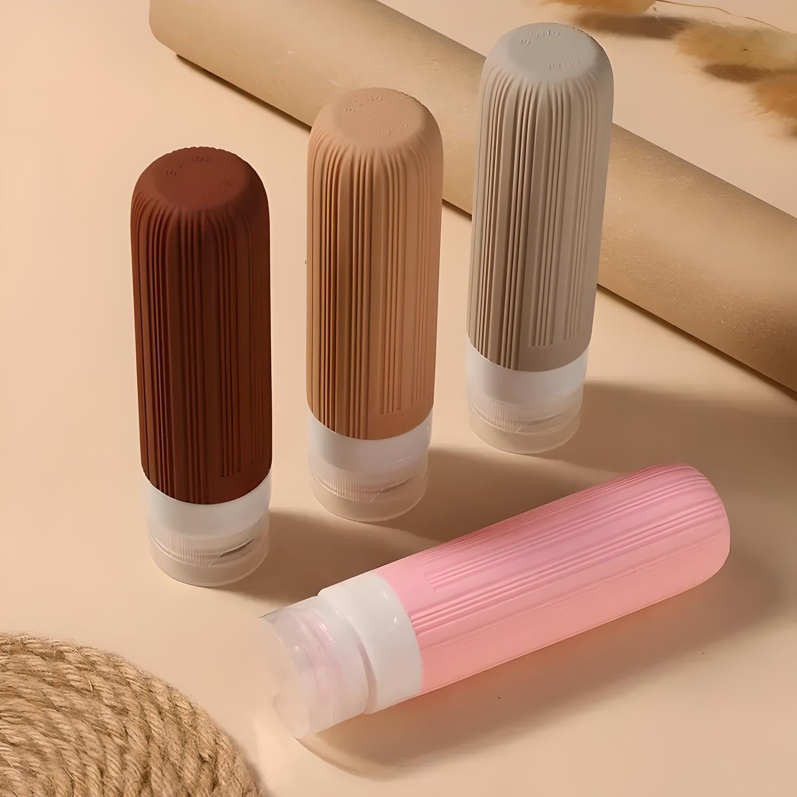 Silicone travel bottles in brown, beige, and pink with ribbed design on a neutral background. Ideal for toiletries, leak-proof, portable containers.