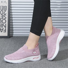 Pink slip-on sneakers with breathable mesh design, cushioned sole, and logo detail. Comfortable women's walking shoes for casual wear.