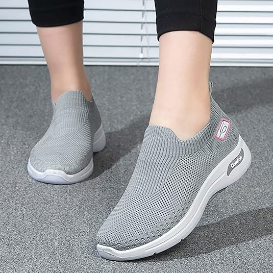 Gray slip-on walking shoes with breathable mesh upper, cushioned sole, and logo detail, ideal for casual wear and comfort.