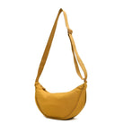 Yellow crescent-shaped crossbody bag with adjustable strap, minimalist design, perfect for casual outings. Fashionable women's accessory.