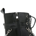 Close-up of a black leather combat boot with zipper and chain details, featuring metal eyelets and laces. Fashion footwear, edgy style.