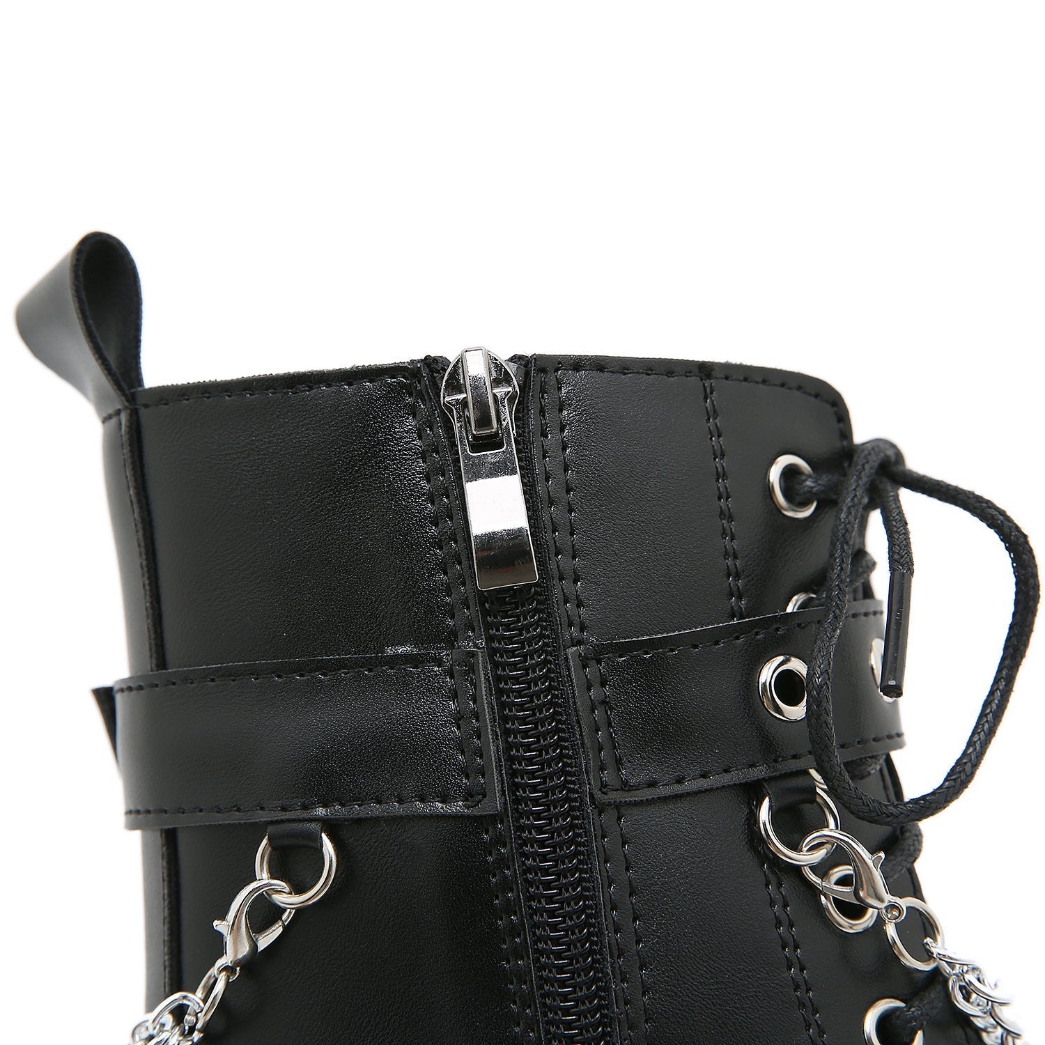 Close-up of a black leather combat boot with zipper and chain details, featuring metal eyelets and laces. Fashion footwear, edgy style.