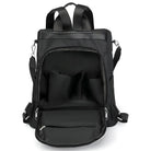 Sleek black backpack with open front pocket, multiple compartments, adjustable straps, and durable zippers. Ideal for travel, school, or work.