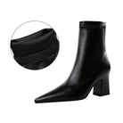 Black leather ankle boot with block heel and pointed toe, featuring a close-up of the cushioned interior. Stylish women's footwear for fashion.