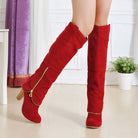 Red knee-high suede boots with gold zippers, high heels, and a stylish design, perfect for fashion-forward women seeking trendy footwear.