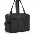 Sleek black nylon tote bag with padded design, featuring multiple zippered pockets and sturdy handles. Ideal for travel, work, or gym use.