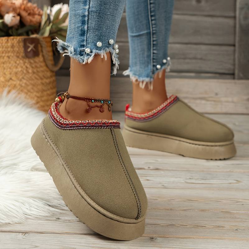 Women's casual slip-on shoes with thick soles, beige color, paired with frayed hem jeans and anklet. Stylish footwear for comfort and fashion.