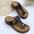 Black leather men's sandals with buckle, brown sole, and quilted footbed on a white background. Perfect for casual summer wear.