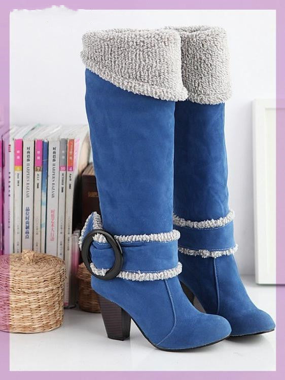 Blue suede knee-high boots with faux fur trim and chunky heels, featuring a decorative buckle. Stylish winter footwear for women.