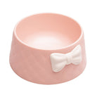 Pink ceramic pet bowl with quilted texture and white bow, perfect for stylish dog or cat feeding. Durable, elegant design for modern pet owners.