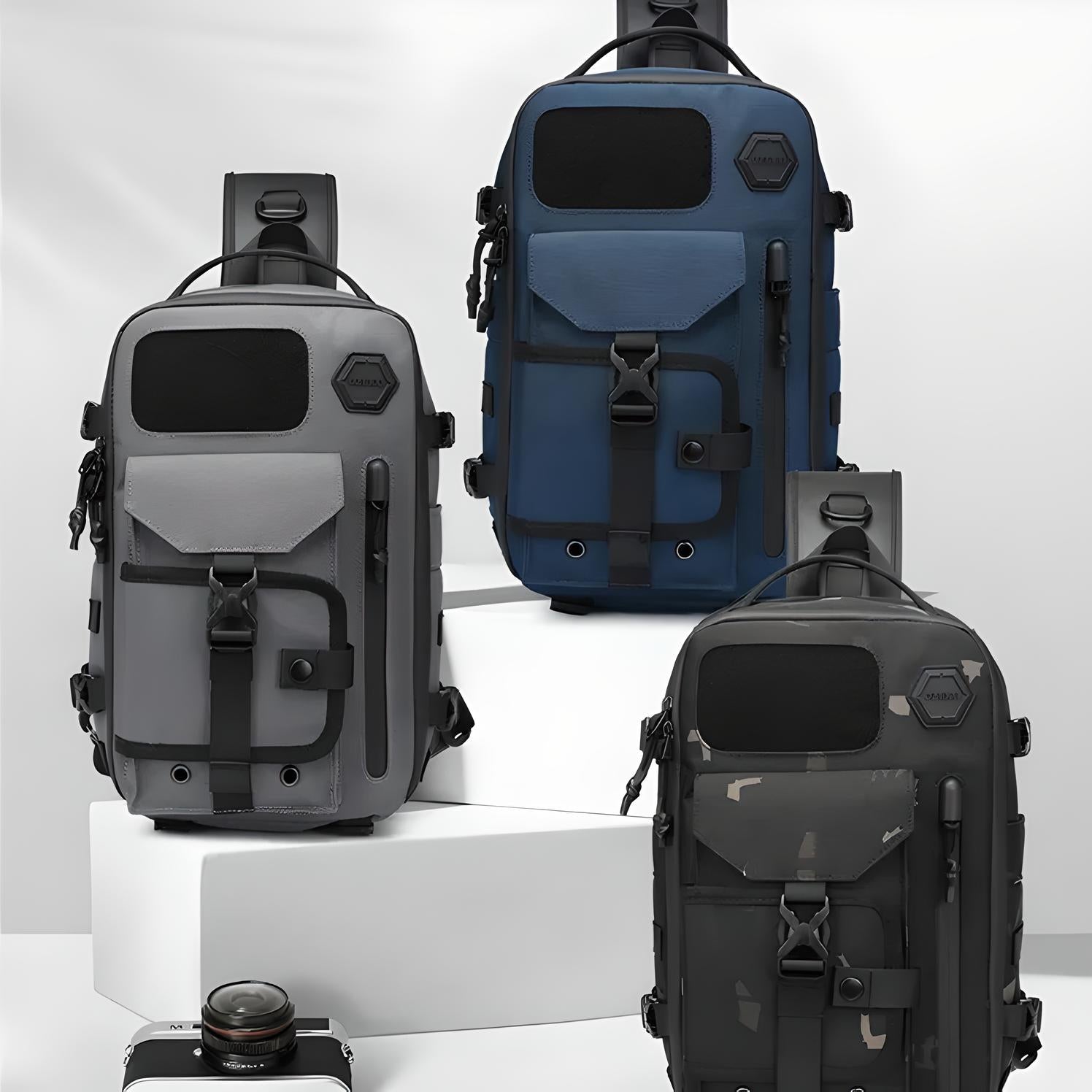 Three stylish tactical sling bags in gray, blue, and camo displayed on white pedestals, ideal for urban travel and outdoor adventures.