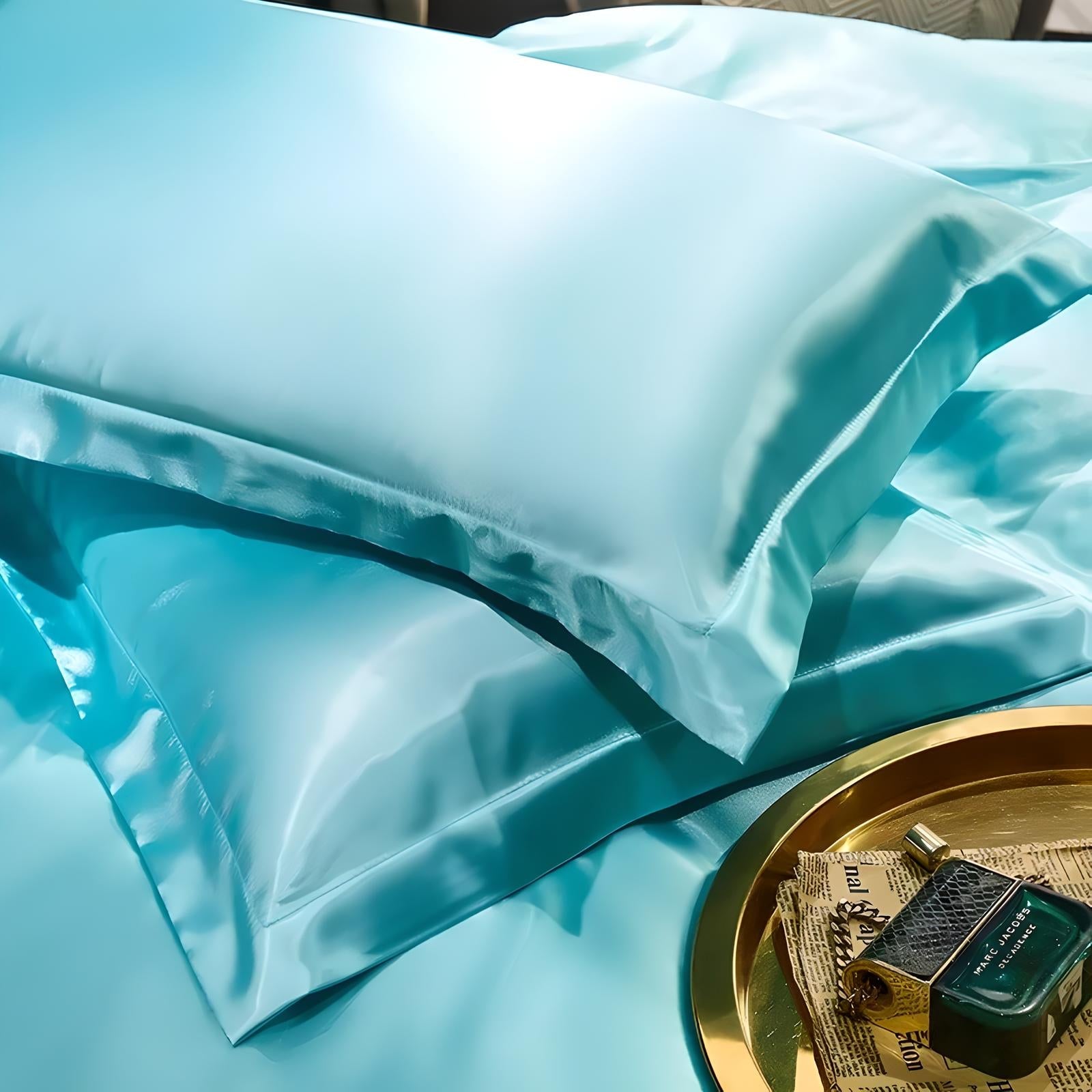 Luxurious aqua blue silk pillowcases on a bed, showcasing smooth texture and elegant sheen. Perfect for enhancing bedroom decor and comfort.