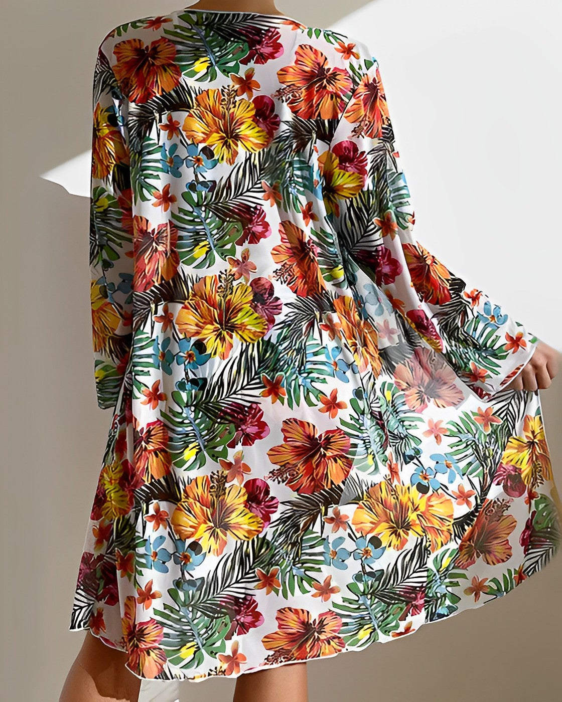 Floral print beach cover-up dress with vibrant tropical flowers and leaves, lightweight and flowy, perfect for summer fashion and beachwear.