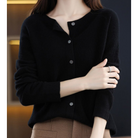 Woman wearing black cashmere cardigan sweater, buttoned, long sleeves, stylish winter fashion.