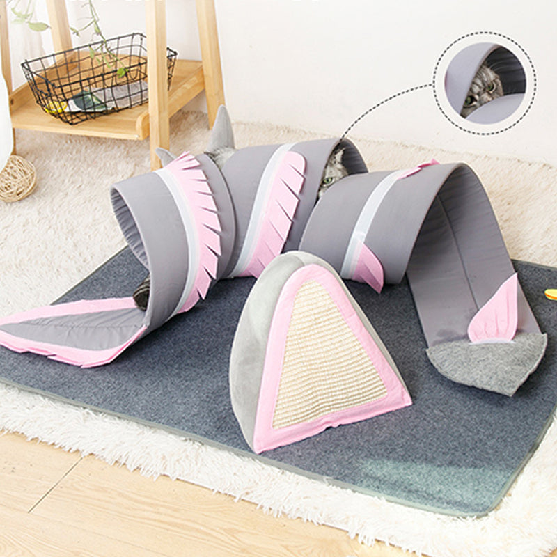 Cat play tunnel with pink and gray shark design, featuring multiple entry points and a cozy interior. Ideal for pet entertainment and exercise.