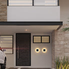 Modern house entrance with sleek black door, horizontal slats, illuminated wall lights, and minimalist design. Contemporary architecture, stylish facade.