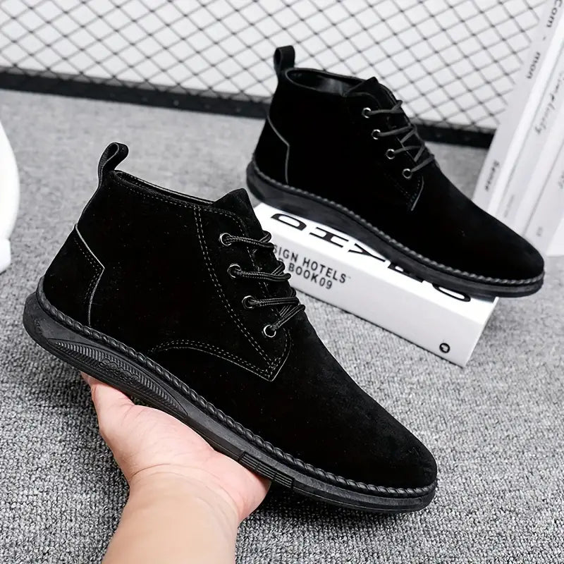 Black suede men's ankle boots with lace-up design, showcased on a textured gray surface. Stylish, comfortable footwear ideal for casual and formal wear.