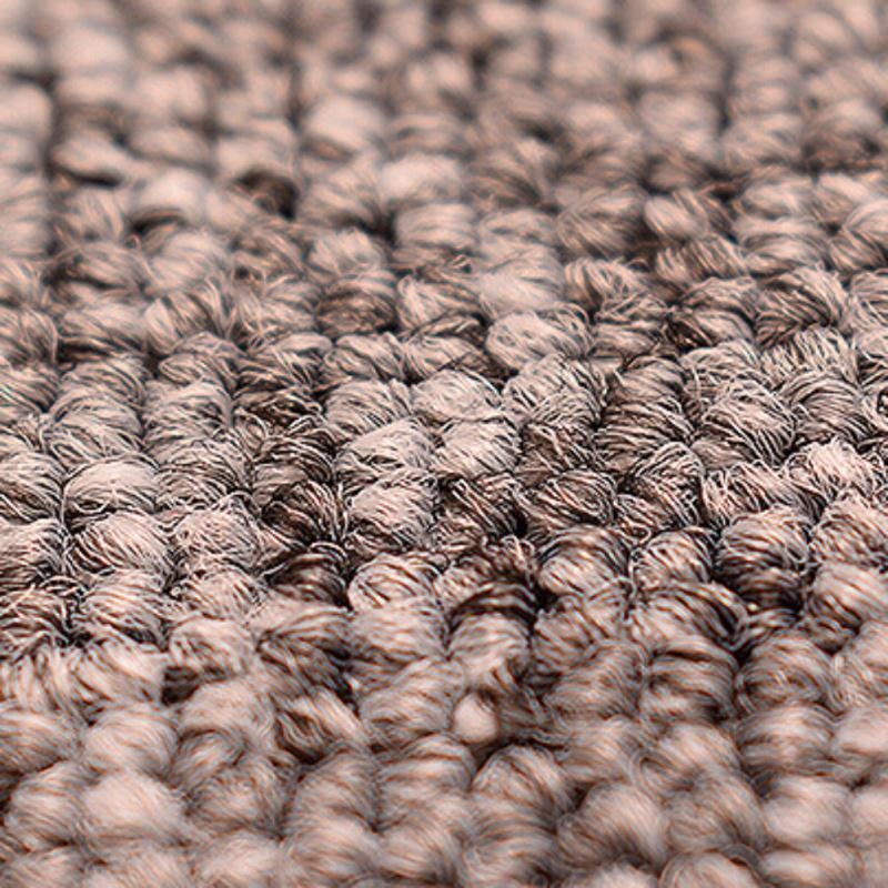 Close-up of textured brown carpet fibers, showcasing detailed loop pile design. Ideal for home decor, flooring, and interior design inspiration.