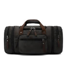 Sleek black leather duffel bag with multiple zippered compartments and brown handles, perfect for travel or gym use. Durable and stylish design.