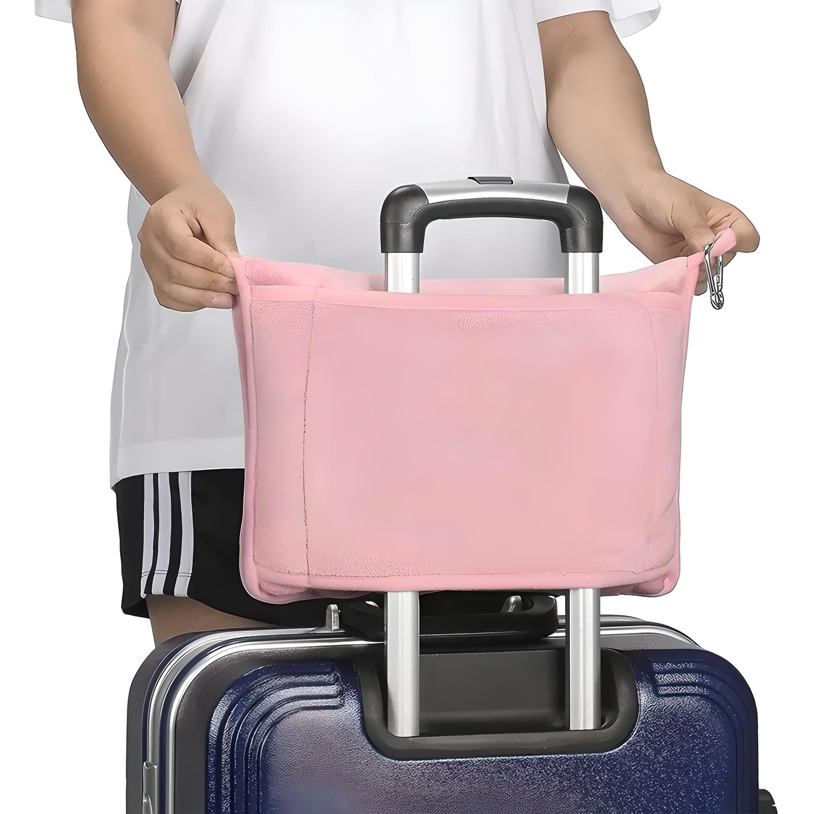 Person attaching a pink travel organizer to a suitcase handle. Travel accessory, luggage organizer, suitcase attachment, travel convenience.