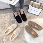 Women's cozy slip-on loafers in black, beige, and brown on a plush carpet. Perfect for casual wear, featuring soft, fuzzy material and durable soles.