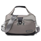 Stylish gray travel duffel bag with adjustable shoulder strap, front zipper pocket, and durable handles. Perfect for gym, weekend trips, or carry-on luggage.