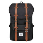 Black vintage backpack with brown leather straps, front pocket, and buckle closures. Ideal for travel, hiking, or school. Durable and stylish design.