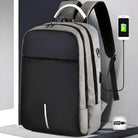 Anti-theft laptop backpack with USB charging port, sleek black and gray design, ergonomic straps, ideal for travel and business use.