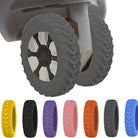 Close-up of stroller wheels with textured treads, featuring a variety of colorful tire options below, including yellow, black, purple, pink, orange, and blue.