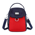 Red and navy crossbody bag with silver hardware, adjustable strap, and front flap. Stylish women's accessory, perfect for casual and travel use.