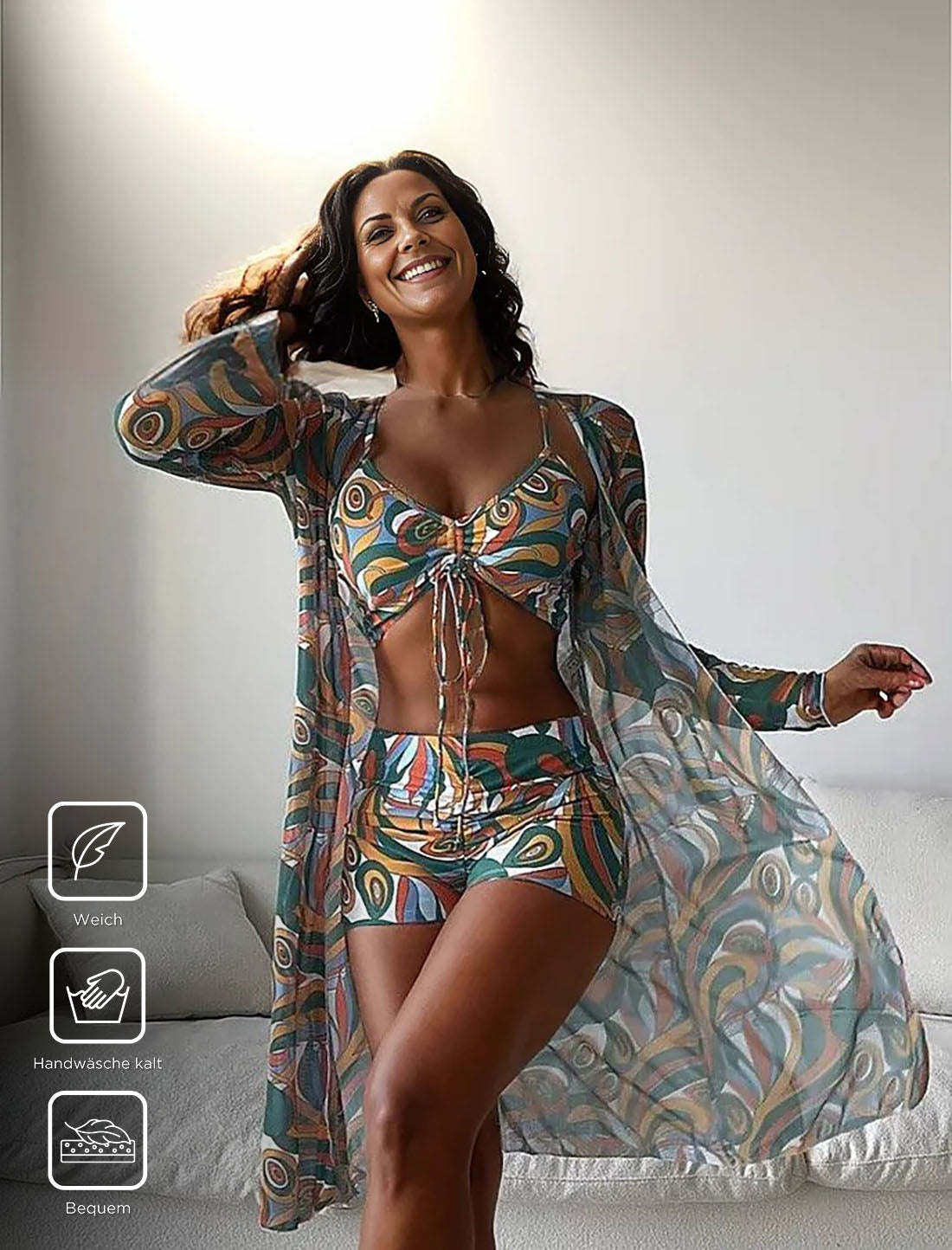 Woman in colorful bohemian loungewear set with abstract patterns, featuring a long sheer robe, crop top, and shorts. Comfortable, stylish homewear.