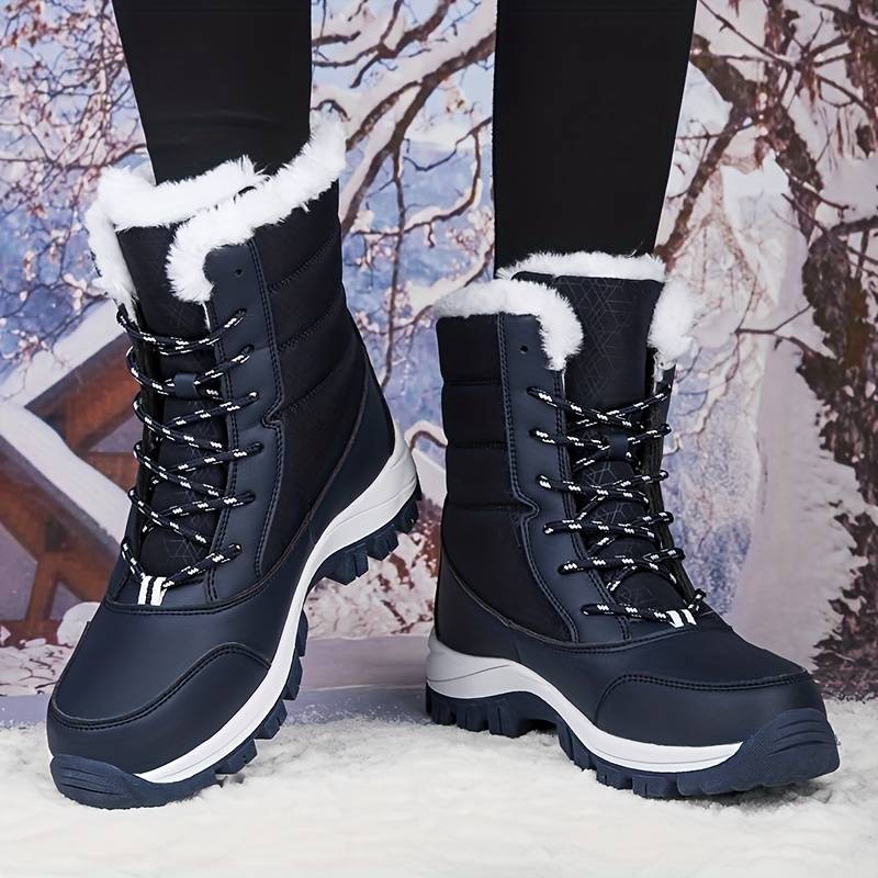 Women's black winter snow boots with white fur lining, durable rubber soles, and lace-up design, perfect for cold weather and outdoor activities.