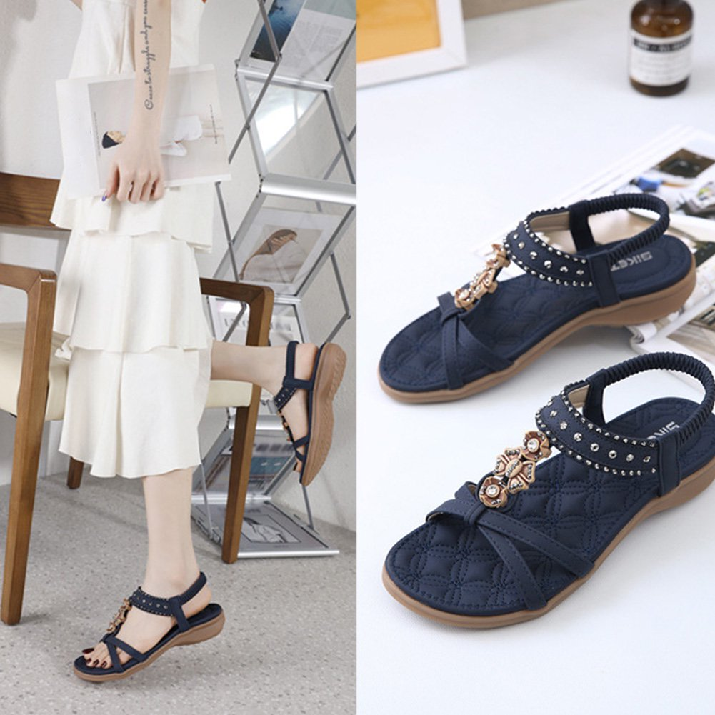 Navy blue women's sandals with rhinestone embellishments, quilted design, and comfortable sole. Perfect for summer fashion and casual wear.