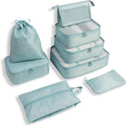 Light blue travel packing cubes set with various sizes, including a drawstring bag and zippered pouches, ideal for organized luggage and efficient packing.