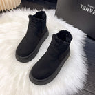 Black women's winter snow boots with plush lining, anti-slip soles, and waterproof design on a white fur rug. Ideal for casual wear and cold weather.