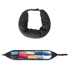 Black travel neck pillow with hidden storage compartments, showcasing rolled clothes inside. Ideal for travel organization and comfort.