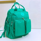 Teal backpack with multiple zippered compartments, front pockets, and top handles on a white background. Ideal for school, travel, or daily use.