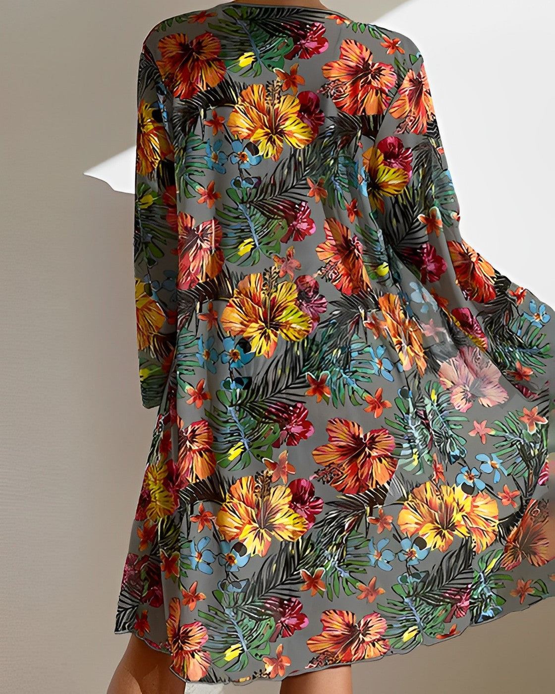 Vibrant floral print dress with tropical hibiscus and palm leaf patterns, perfect for summer fashion. Lightweight, colorful, and stylish beachwear.