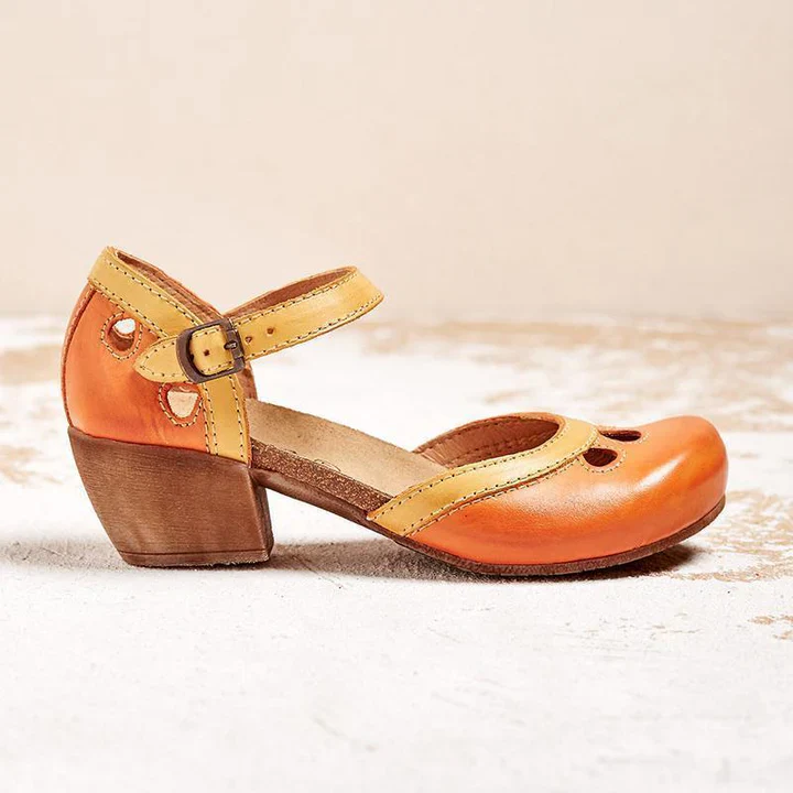 Orange and yellow leather Mary Jane shoe with wooden block heel, featuring cutout details and adjustable ankle strap. Vintage-inspired women's footwear.