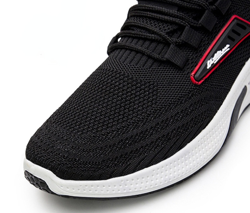 Black athletic running shoe with breathable mesh upper, white cushioned sole, and red accents. Ideal for sports, fitness, and casual wear.