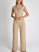 Beige sleeveless jumpsuit with wide-leg pants, featuring a fitted waist and high neckline. Women's fashion, elegant casual wear, neutral tones.