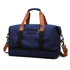 Blue travel duffel bag with brown handles and detachable shoulder strap, featuring a spacious main compartment and durable zippers. Ideal for travel.